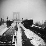 "Snow-covered train tracks, rooftops and arches of the Brooklyn Bridge seen from the rear of a train." March 14, 1888